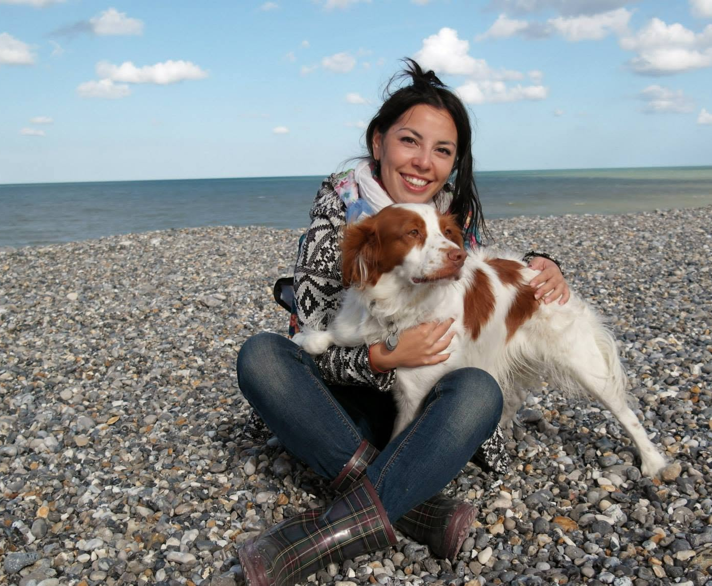 Oriane avec son chien sur une plage de galets